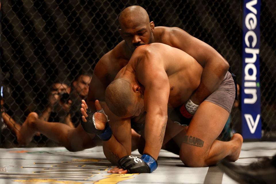 Jones (top) submitted Ciryl Gane in Round 1 in March to win the UFC heavyweight title (Getty Images)