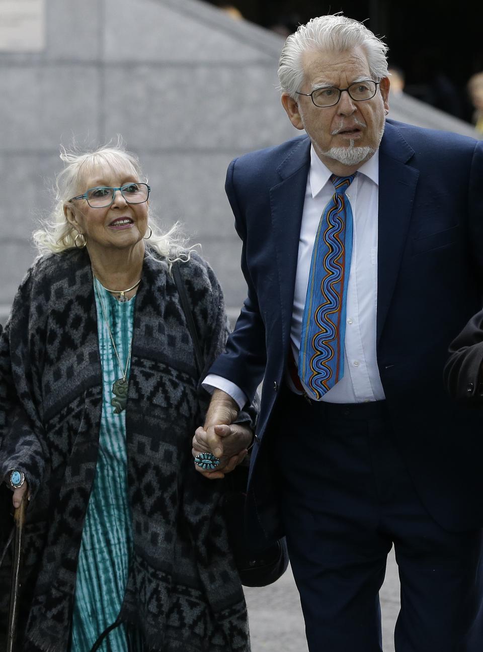 Veteran entertainer Rolf Harris arrives with his wife Alwen Hughes at Southwark Crown Court in London, Tuesday, May 6, 2014. Harris is charged with nine counts of indecent assault and four counts of making indecent images of children. (AP Photo/Kirsty Wigglesworth)