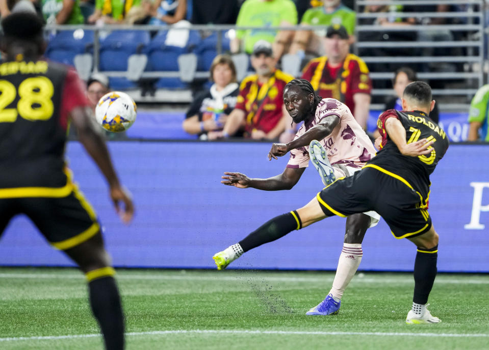 Portland Timbers forward Yimmi Chará (23) tries to curve the ball around Seattle Sounders midfielder Alex Roldan (16) during the first half of an MLS soccer match Saturday, Sept. 2, 2023, in Seattle. (AP Photo/Lindsey Wasson)