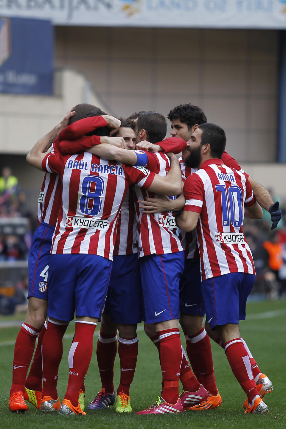 Atletico's Raul García, left, celebrates his goal with teammates during a Spanish La Liga soccer match between Atletico Madrid and Valladolid at the Vicente Calderon stadium in Madrid, Spain, Saturday, Feb. 15, 2014. (AP Photo/Gabriel Pecot)