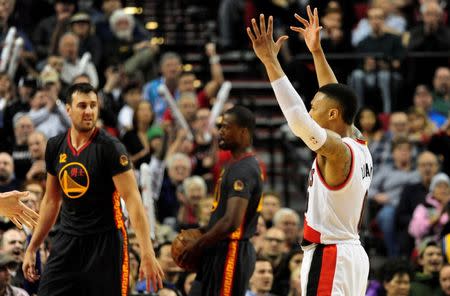 Feb 19, 2016; Portland, OR, USA; Portland Trail Blazers guard Damian Lillard (0) reacts after hitting a three point shot during the third quarter of the game against the Golden State Warriors at the Moda Center at the Rose Quarter. Lillard scored 51 points as the Blazers won the game 137-105. Mandatory Credit: Steve Dykes-USA TODAY Sports