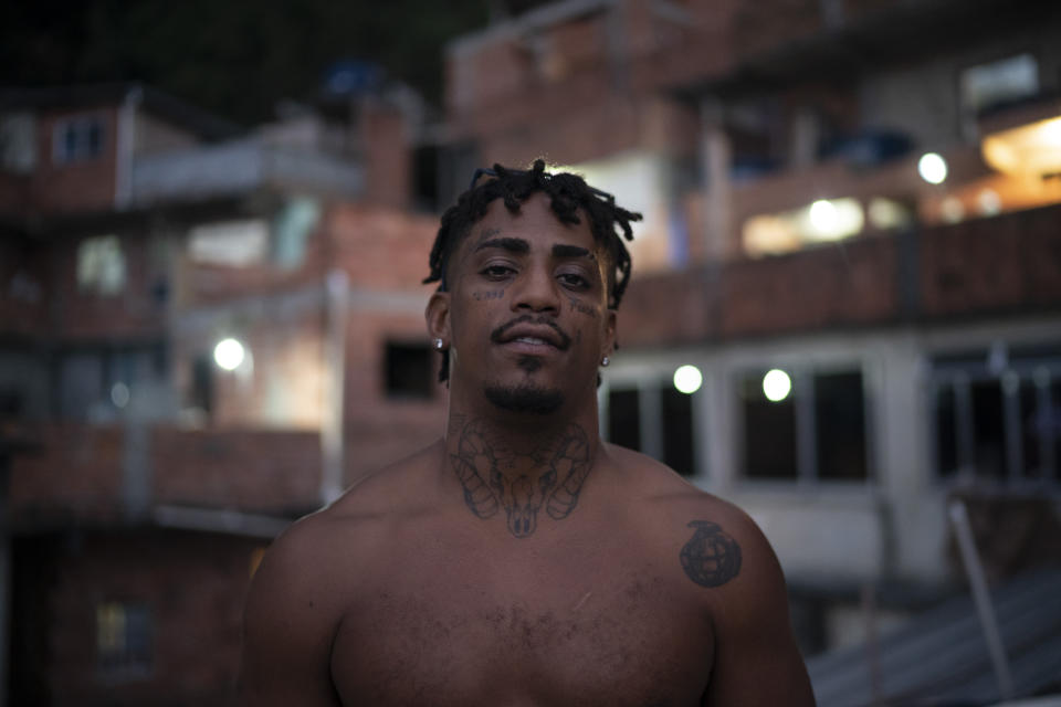 Trap de Cria artist Vitor Oliveira, known as "MC Piloto", poses for a photo on the rooftop of his home and recording studio at the Rocinha slum in Rio de Janeiro, Brazil, Monday, April 12, 2021. Oliveira has recorded 10 tracks and two videos for his 18-song project. From his elevated perch, music can sometimes seem a distant dream, but he visualizes himself dodging all pitfalls. “But I’m prepared to take off,” he says. (AP Photo/Felipe Dana)