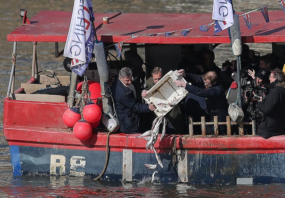 Nigel Farage dumps dead fish into the Thames in protest over EU fishing vessels retaining rights in British waters (Getty)