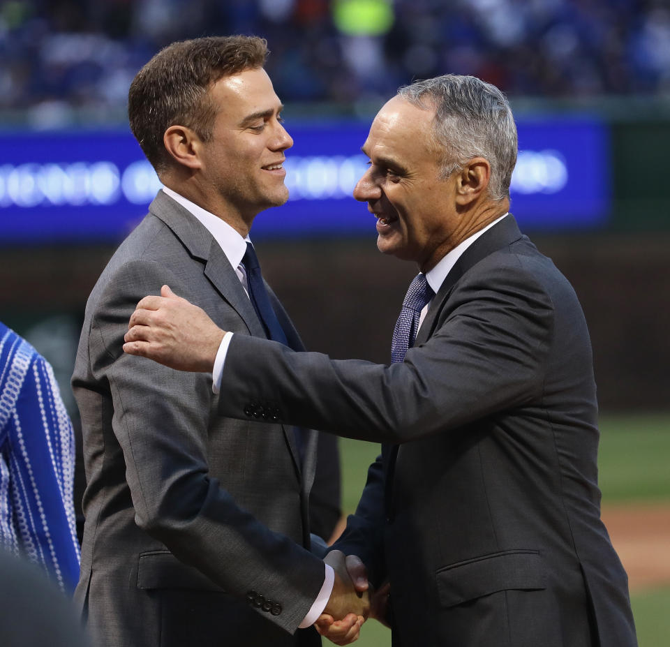 CHICAGO, IL - APRIL 12:  President Theo Epstein of the Chicago Cubs
is congratulated by Rob Manfred, comissioner of Major League baseball, during a ring ceremony before a game against the Los Angeles Dodgers at Wrigley Field on April 12, 2017 in Chicago, Illinois.  (Photo by Jonathan Daniel/Getty Images)