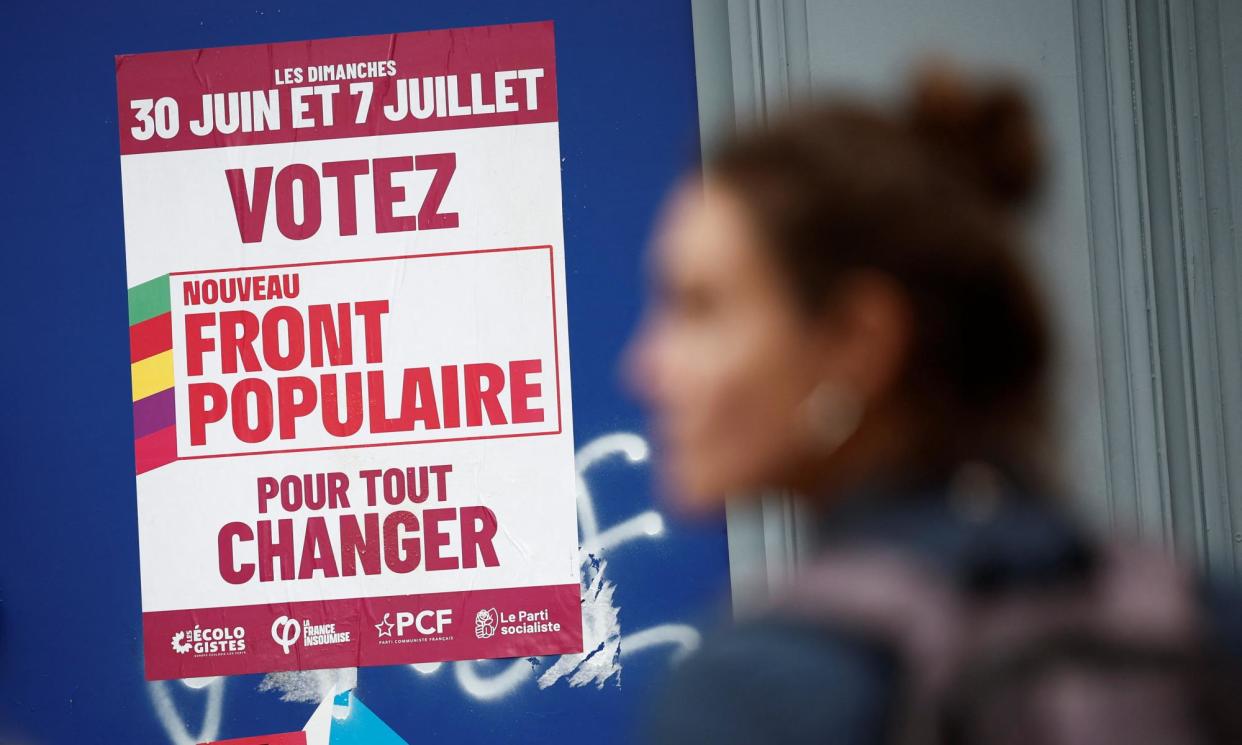 <span>A woman passes a poster for the New Popular Front. It is not yet clear who will lead the NFP or be its candidate for prime minister.</span><span>Photograph: Benoît Tessier/Reuters</span>