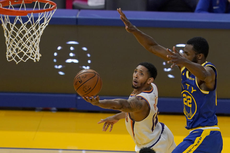 Phoenix Suns guard Cameron Payne, left, shoots against Golden State Warriors forward Andrew Wiggins (22) during the first half of an NBA basketball game in San Francisco, Tuesday, May 11, 2021. (AP Photo/Jeff Chiu)