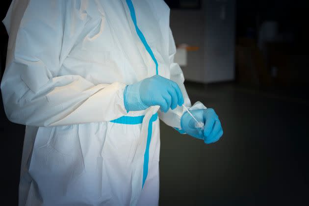 Doctor using swab during covid-19 test (Photo: deimagine via Getty Images)