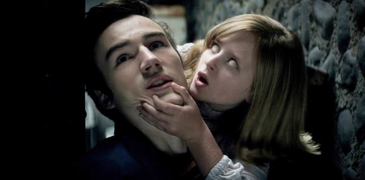 A girl grab's a man's chin in Ouija: Origin of Evil.