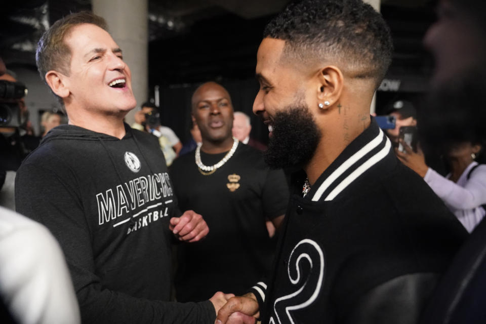 Dallas Mavericks owner Marc Cuban, left, greets NLF football free agent Odell Beckham Jr. after an NBA basketball game between the Phoenix Suns and Dallas Mavericks in Dallas, Monday, Dec. 5, 2022. (AP Photo/LM Otero)