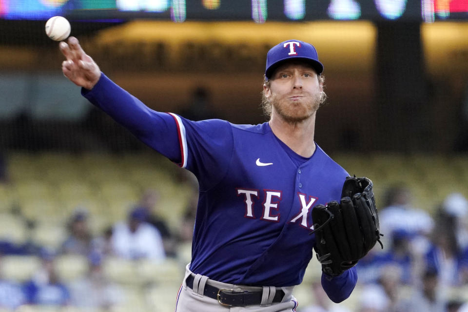 Texas Rangers starting pitcher Mike Foltynewicz throws to first as he tries to get Los Angeles Dodgers' Mookie Betts off base during the first inning of a baseball game Friday, June 11, 2021, in Los Angeles. (AP Photo/Mark J. Terrill)