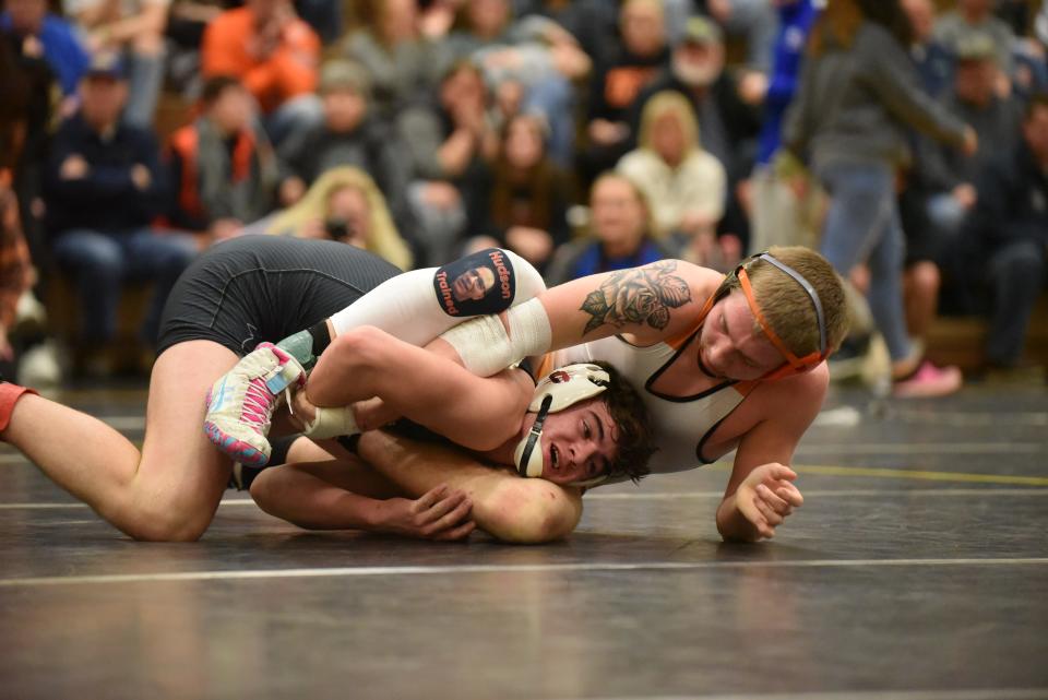 Clinton's Bryce Randolph looks to escape during the 157 pound championship match against Hudson's Aden Barrett at the Lenawee County All-Star Wrestling Tournament at Adrian College. Clinton was second and Hudson third in the Lenawee County Athletic Association Championships Friday night.