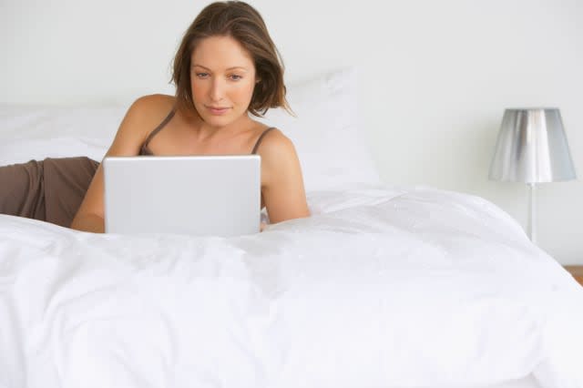 Woman on bed with laptop