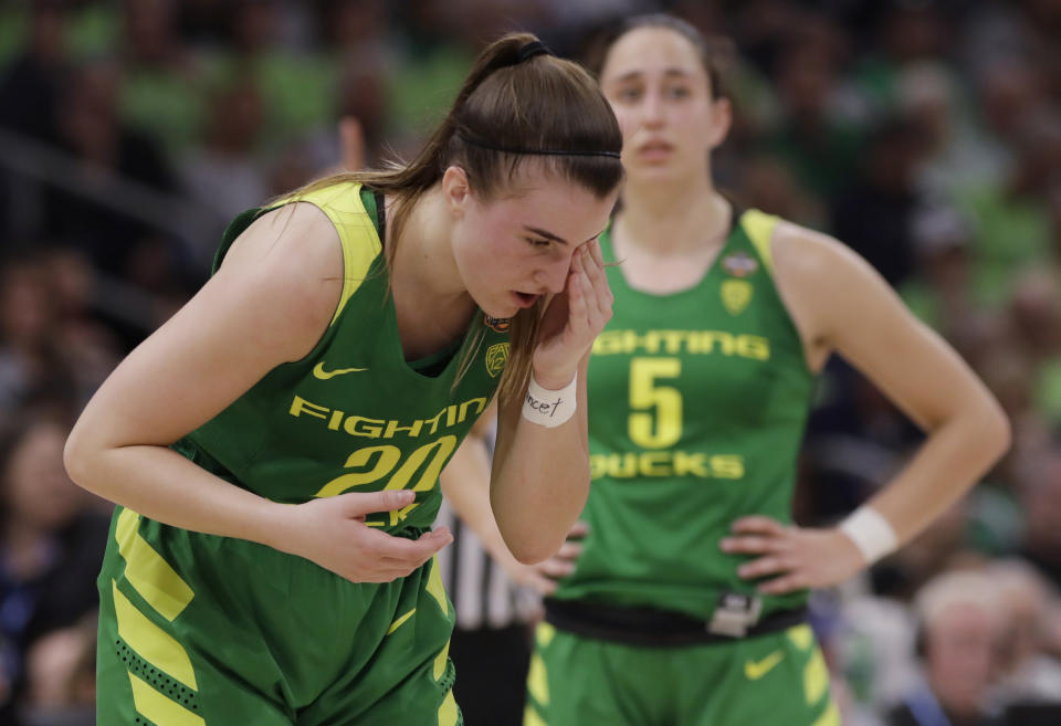 Oregon guard Sabrina Ionescu (20) wipes her eye during the second half of a women's Final Four NCAA college basketball semifinal tournament game against the Baylor, Friday, April 5, 2019, in Tampa, Fla. (AP Photo/Chris O'Meara)