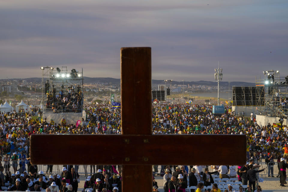 People waiting for the start of a vigil with Pope Francis, ahead of the 37th World Youth Day, flock together at the Parque Tejo in Lisbon, Saturday, Aug. 5, 2023. On Sunday morning, the last day of his five-day trip to Portugal, Francis is to preside over a final, outdoor Mass on World Youth Day – when temperatures in Lisbon are expected to top 40 degrees C (104F) – before returning to the Vatican. (AP Photo/Gregorio Borgia)