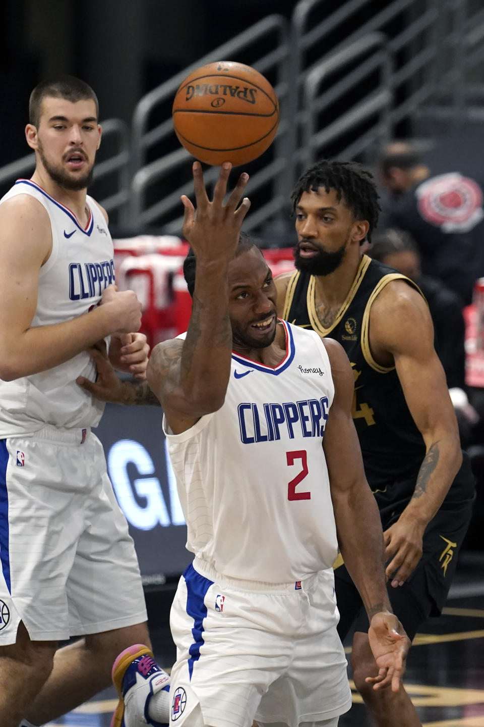 Los Angeles Clippers forward Kawhi Leonard (2) throws up a shot after getting fouled by Toronto Raptors center Khem Birch (24) during the second half of an NBA basketball game Tuesday, May 11, 2021, in Tampa, Fla. (AP Photo/Chris O'Meara)