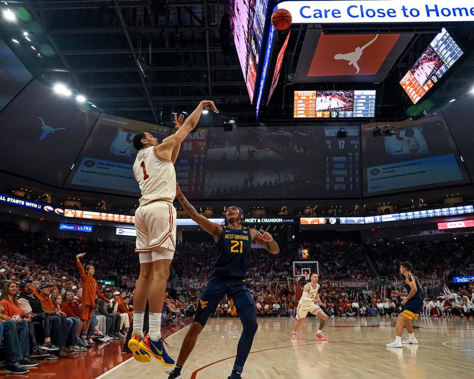 Texas forward Dylan Disu launches a 3-pointer in the Longhorns' win over West Virginia Saturday. Disu earned his first Big 12 player of the week award after averaging 27.5 points in two games last week.