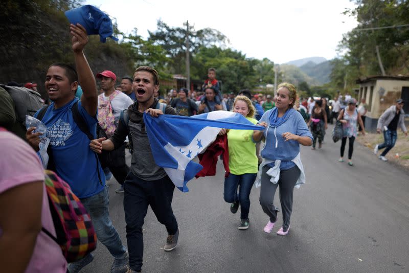 Hondurans, part of a caravan of migrants heading toward the United States, break a blockade made by Guatemala's police at the border between Honduras and Guatemala in Agua Caliente