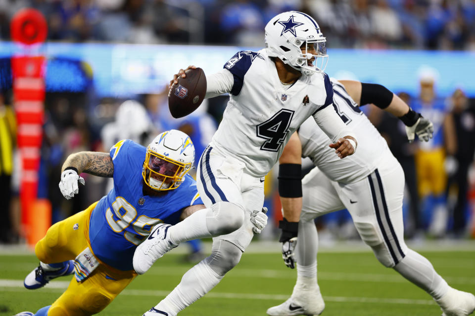 Dallas Cowboys quarterback Dak Prescott evades the rush against the Chargers on Monday night. (Robert Gauthier / Los Angeles Times via Getty Images)