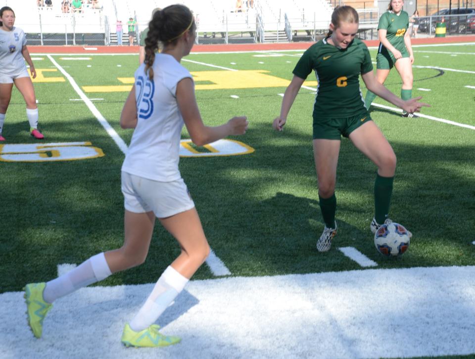 Elyse Rogier of Flat Rock tries to control the ball as Maddie Kreps of Ida closes in during a 5-0 Flat Rock win in a district tournament game on Wednesday, May 22, 2024.