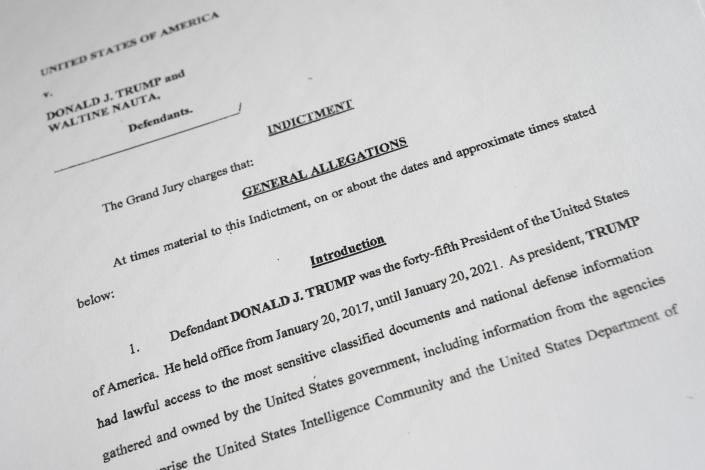 A photo shows a copy of the indictment of former President Donald Trump and his aide Waltine Nauta, brought by the United States Department of Justice.  Former President Trump was charged with multiple counts in a 49-page indictment.