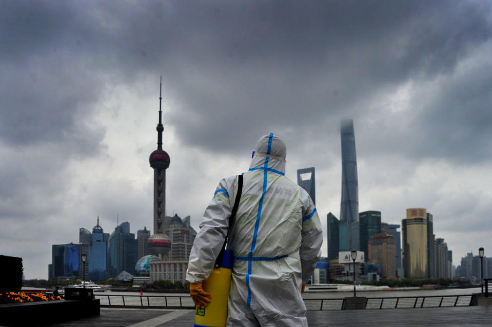 A sanitation worker wearing personal protective equipment conducts disinfection work at the Bund on March 31, 2022 in Shanghai, China.<span class="copyright">Photo by Yang Jianzheng/VCG via Getty Images</span>