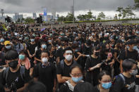 Protesters wearing masks gather near the Legislative Council as they continuing protest against the unpopular extradition bill in Hong Kong, Monday, June 17, 2019. A member of Hong Kong's Executive Council says the city's leader plans to apologize again over her handling of a highly unpopular extradition bill. (AP Photo/Kin Cheung)