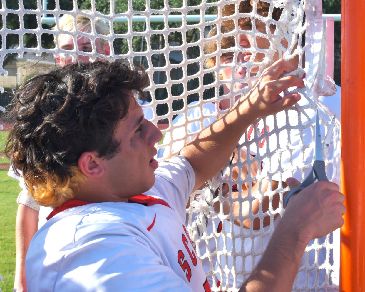 St. Andrew's Nick Testa cuts the net for remembrance as a senior in a regional final game against St. John Paul II on May 4, 2024.