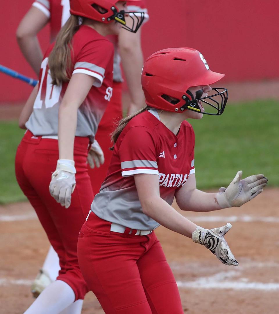 Alyssa Hochstetler of Springfield applauds her teammate Erin Stubbs after Stubbs hit a three-run double during the seventh inning of a 2022 Division II district semifinal at Firestone Stadium.