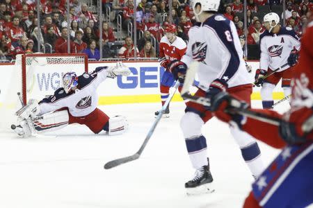 Jan 12, 2019; Washington, DC, USA; Columbus Blue Jackets goaltender Joonas Korpisalo (70) makes a save on Washington Capitals defenseman John Carlson (74) in the first period at Capital One Arena. Mandatory Credit: Geoff Burke-USA TODAY Sports