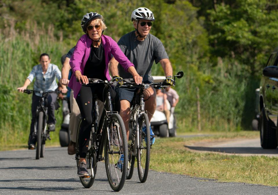 President Joe Biden and first lady Jill Biden ride their bikes on a trail at Gordons Pond in Rehoboth Beach, Del., June 18, 2022.