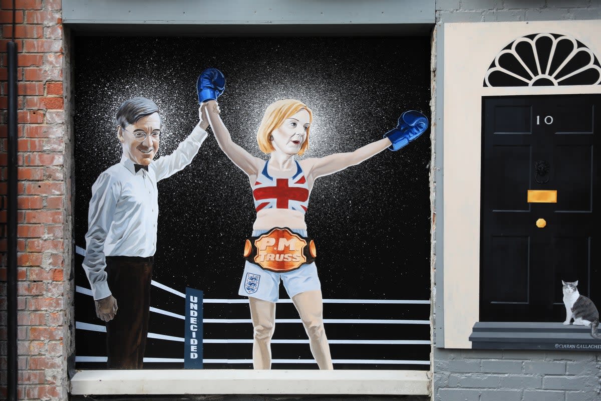A Belfast mural depicting the Tory leadership fight has been updated to acknowledge Liz Truss’s victory (Peter Morrison/PA) (PA Wire)