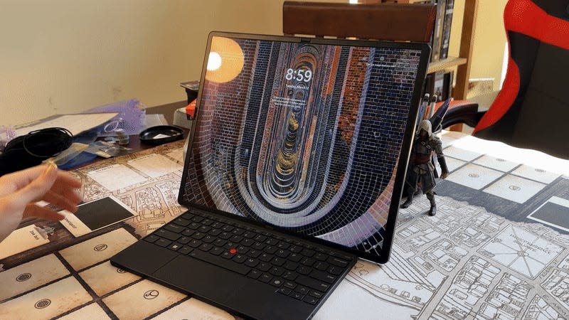 It’s easy enough to take the ThinkPad apart and turn it into a laptop, though you can’t travel around with the keyboard tucked into the screen. - Gif: Kyle Barr / Gizmodo