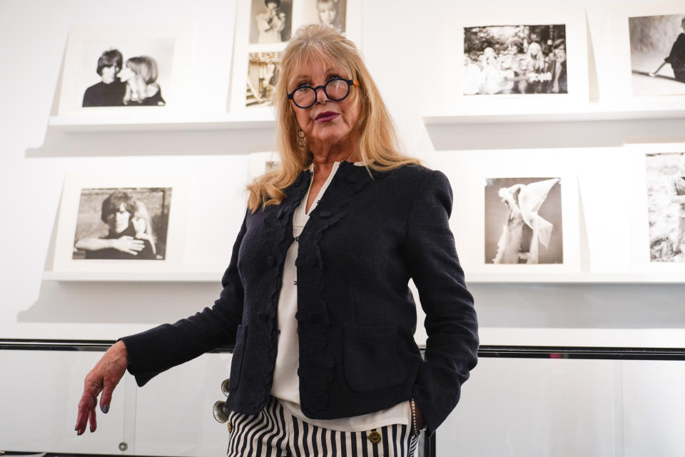 Pattie Boyd next to a set of photographs from The Pattie Boyd Collection, at Christie's, in London, Thursday, March 14, 2024. (AP Photo/Alberto Pezzali)