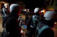 Liu Pengfei, a substitute driver of ride-hailing service platform DiDi Chuxing and his team of fellow drivers wait for clients near a cluster of restaurants in Beijing