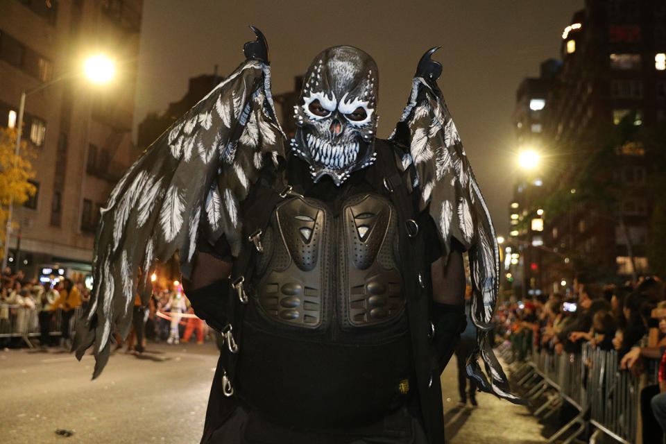 A reveler wears a dark costume with wings marches in the Halloween Parade in New York City. (Photo: Gordon Donovan/Yahoo News)