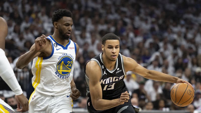 Golden State Warriors forward Andrew Wiggins (22) defends Sacramento Kings forward Keegan Murray (13) during the first half of Game 7 of an NBA basketball first-round playoff series, Sunday, April 30, 2023, in Sacramento, Calif.
