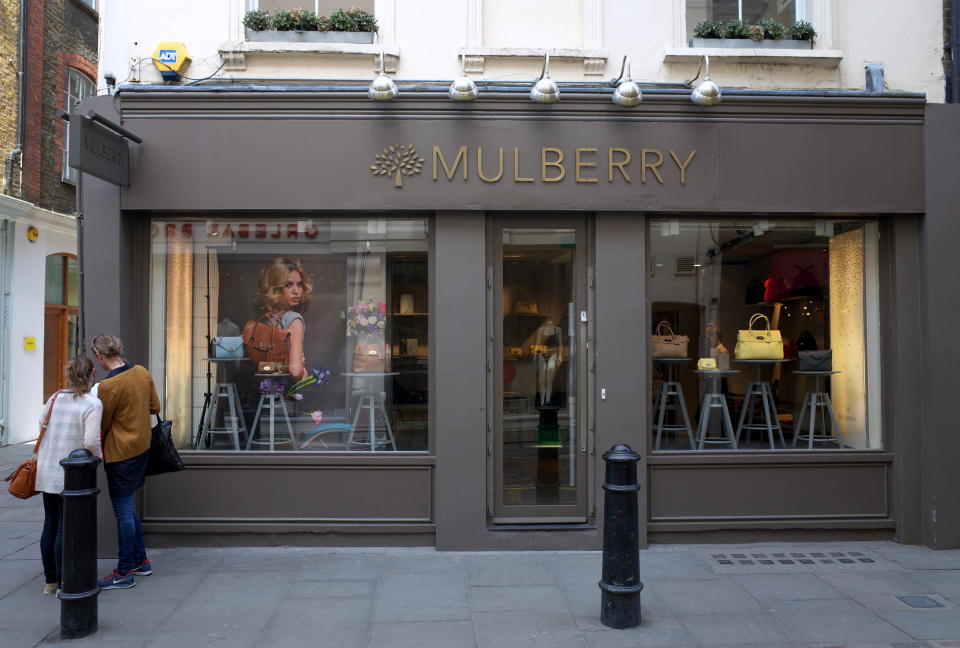 London, United Kingdom - April 16, 2015: People outside a Mulberry Store in London, England. Founded in England in 1971, Mulberry is a fashion company known for leather goods