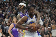 Utah Jazz guard Jordan Clarkson, rear, fouls Golden State Warriors forward Jonathan Kuminga during the second half of an NBA basketball game Wednesday, Dec. 7, 2022, in Salt Lake City. (AP Photo/Rick Bowmer)