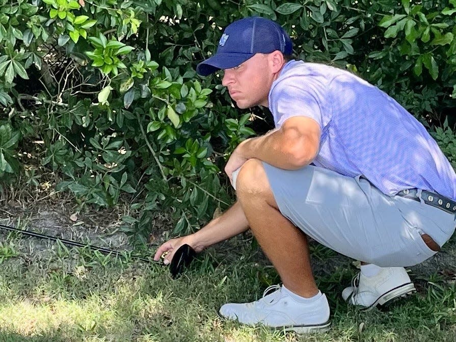 Defending Jacksonville Amateur champion Jason Duff adjusts his driver to give him the proper drop area to the right of the sixth green of the San Jose Country Club on Friday during the second round of the Jacksonville Amateur. Duff's ball was unplayable. He made a bogey and finished with a 71.