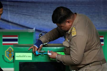 An official seals a ballot box at a polling station, before voting begins in the general election in Bangkok, Thailand, March 24, 2019. REUTERS/Athit Perawongmetha
