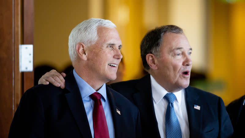 Former Vice President Mike Pence stands with former Gov. Gary Herbert at an event at the Zions Bank Building in Salt Lake City on Friday, April 28, 2023. The event was hosted by the Gary R. Herbert Institute for Public Policy at Utah Valley University.