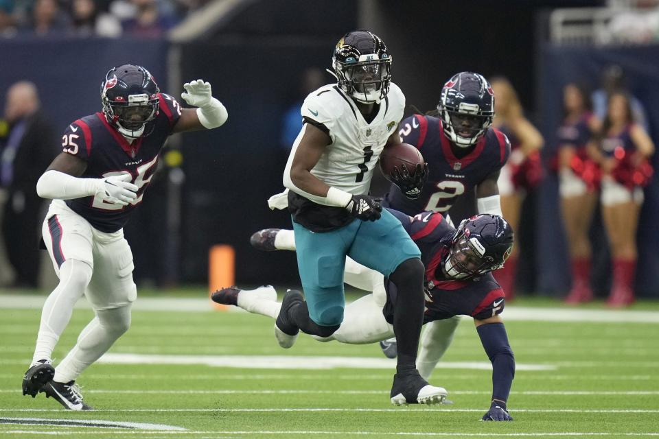 Jacksonville Jaguars running back Travis Etienne Jr. (1) runs for a touchdown against the Houston Texans during the first half of an NFL football game in Houston, Sunday, Jan. 1, 2023. (AP Photo/Eric Christian Smith)