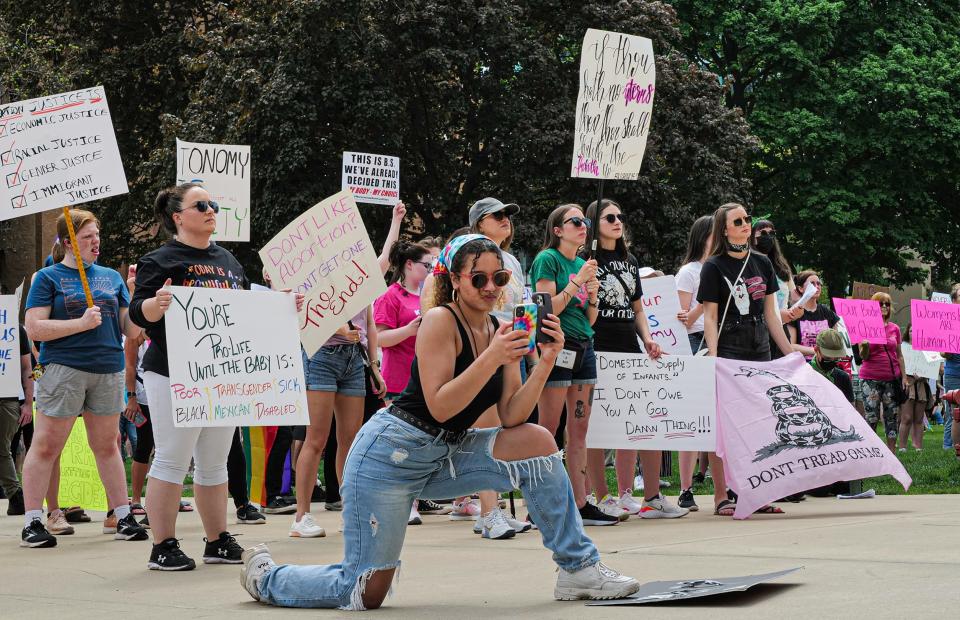 Ashlynn Moore from Hillsdale, Michigan video tapes a speaker at an abortion rights rally at the State Capitol in Lansing, Michigan Sunday, May 15, 2022. Approximately 700 people attended the event.