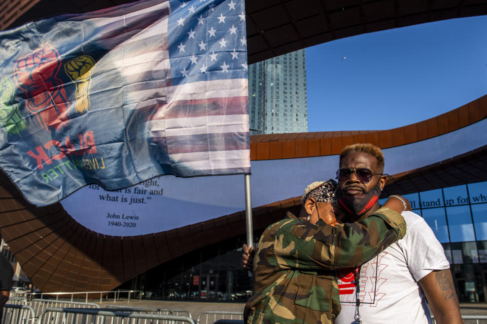 Ingrid Noel, 51, left, weeps on the shoulder of Robert Bolden, at a rally outside the Barclays Center on Tuesday, April 20, 2021 in theBrooklyn borough of New York. Former Minneapolis police Officer Derek Chauvin has been convicted of murder and manslaughter in the death of George Floyd, the explosive case that triggered worldwide protests, violence and a furious reexamination of racism and policing in the U.S. Floyd died last May after Chauvin, a white officer, pinned his knee on or close to the 46-year-old Black man's neck for about 9 1/2 minutes. (AP Photo/Brittainy Newman)