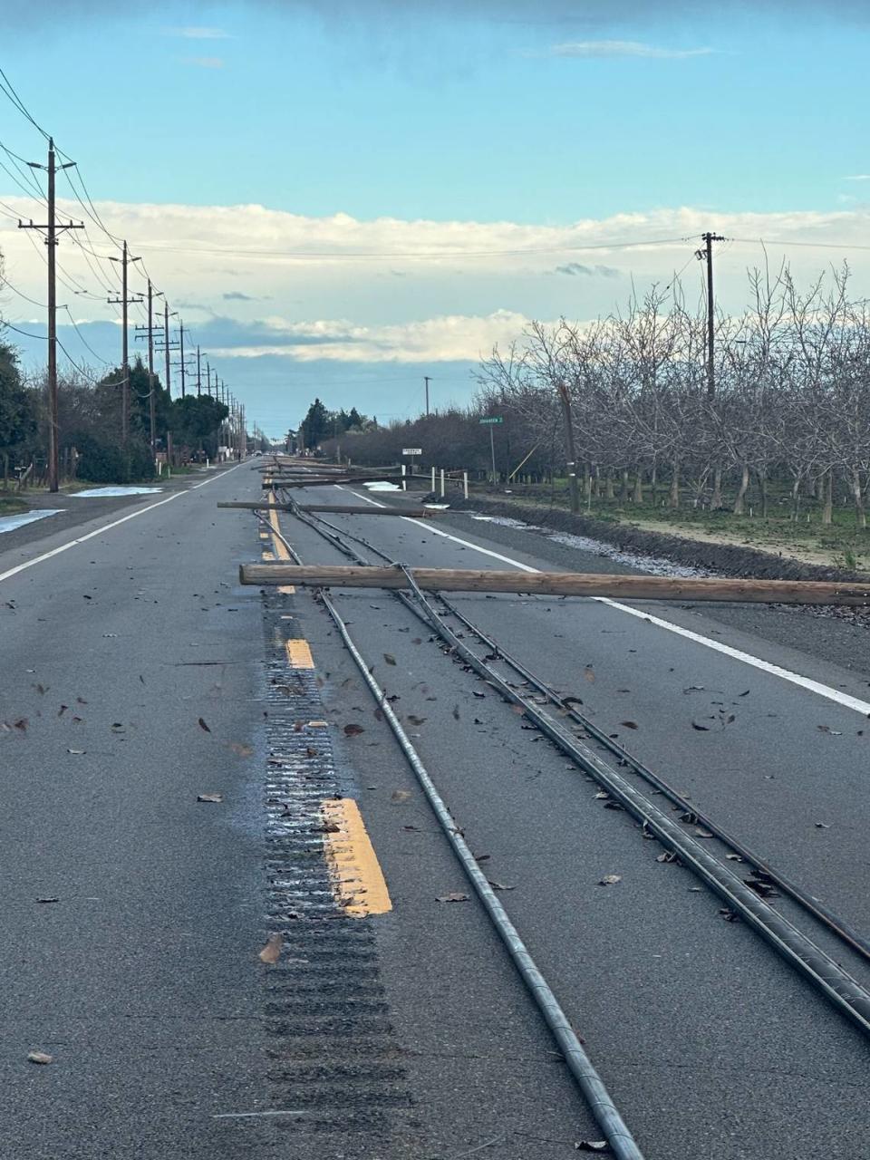 Phone poles and lines lie on Highway 132 east of Empire between Wellsford and Albers/Geer roads on Sunday afternoon, Feb. 4. California Highway Patrol Modesto office