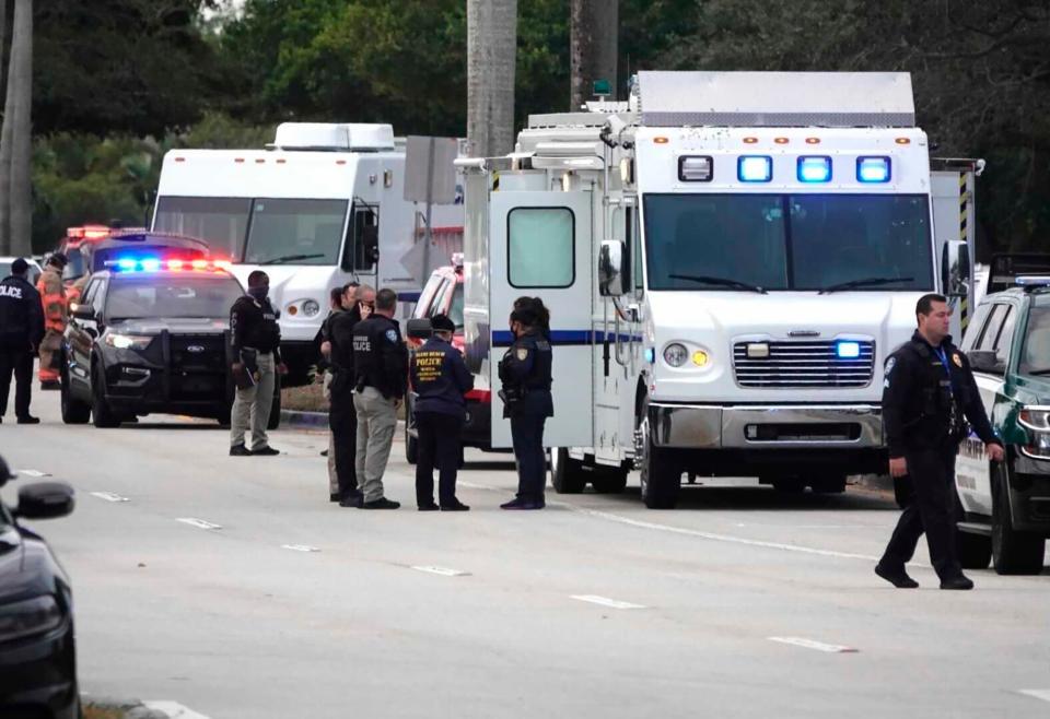 Law enforcement gather near the scene of a shooting in which FBI agents were killed and wounded in Sunrise, Florida, Feb. 2, 2021.