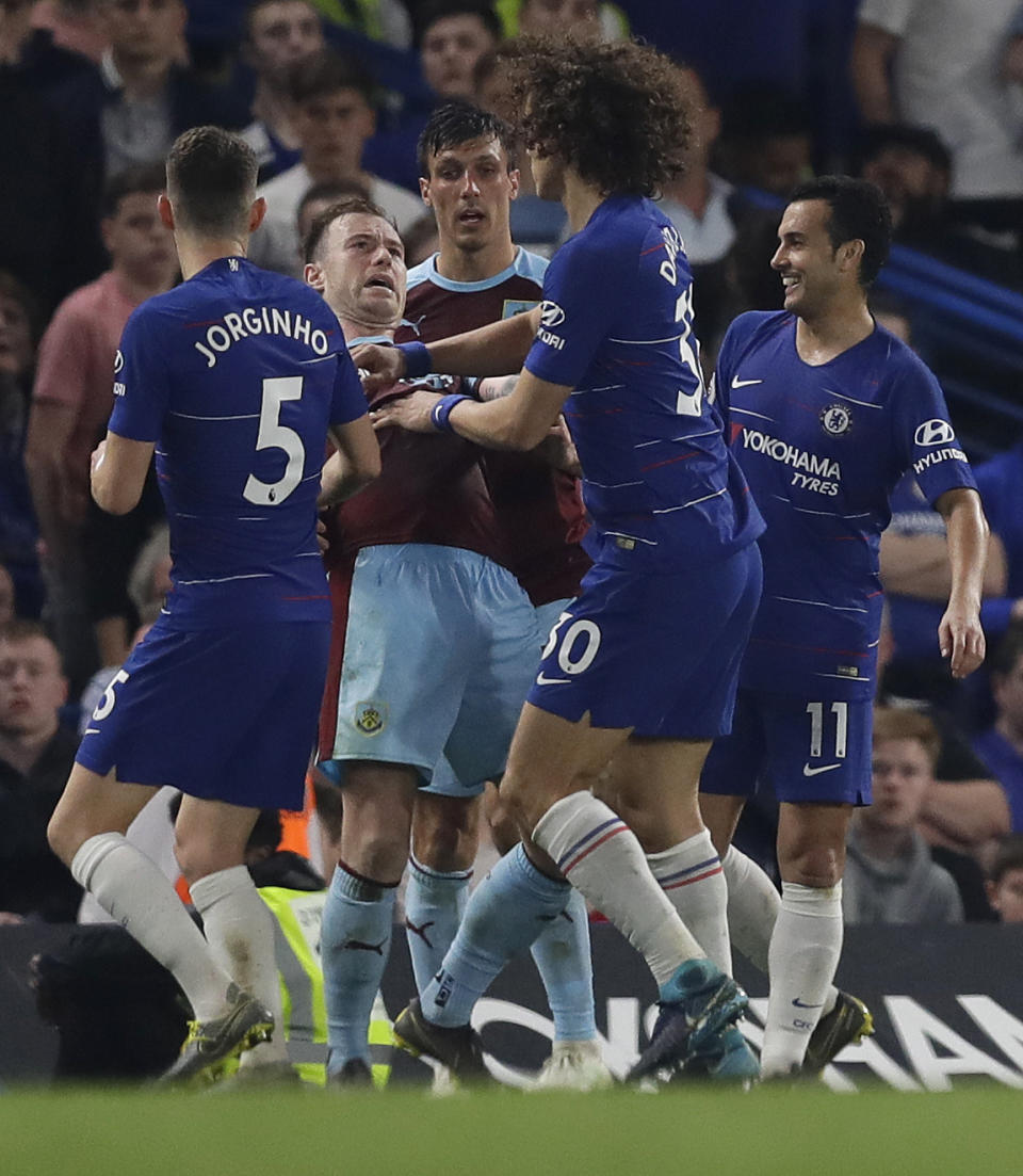 Chelsea's David Luiz and Burnley's Ashley Barnes disagree during the English Premier League soccer match between Chelsea and Burnley at Stamford Bridge stadium in London, Monday, April 22, 2019. (AP Photo/Kirsty Wigglesworth)