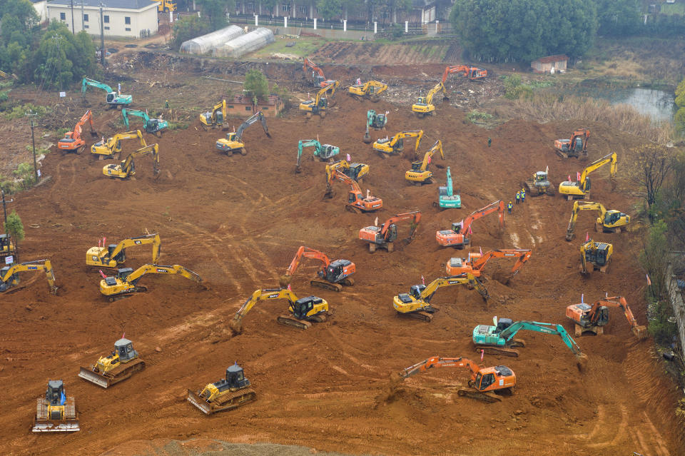 Heavy equipment works at a construction site for a field hospital in Wuhan in central China's Hubei Province, Friday, Jan. 24, 2020. China is swiftly building a 1,000-bed hospital dedicated to patients infected with a new virus that has killed 26 people, sickened hundreds and prompted unprecedented lockdowns of cities during the country's most important holiday. (Chinatopix via AP)