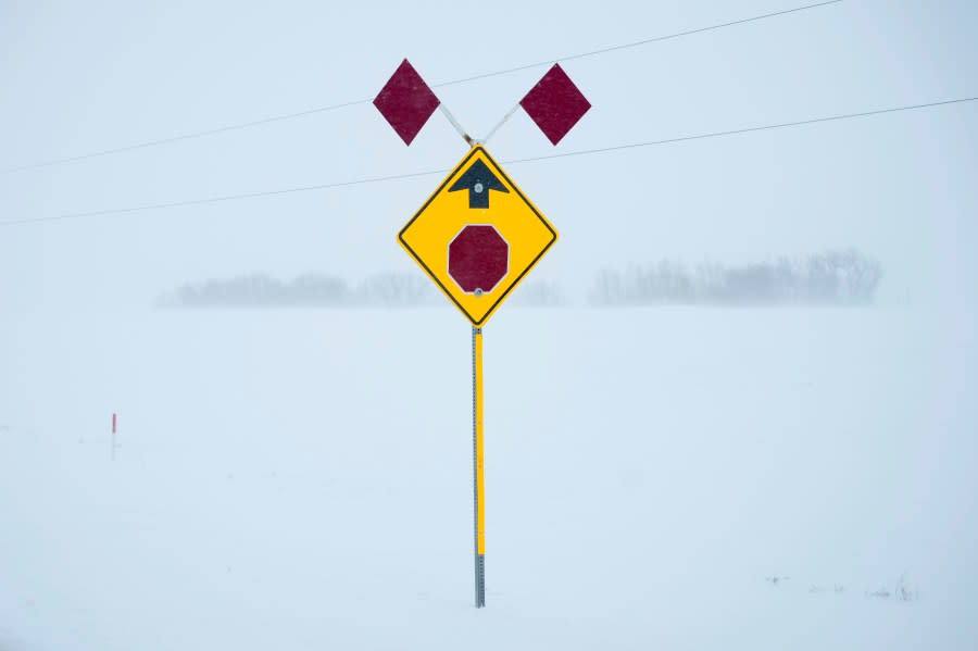 A sign to alert to an intersection is seen during a blizzard near Adaville, Iowa, Friday, Jan. 12, 2024. (AP Photo/Carolyn Kaster)