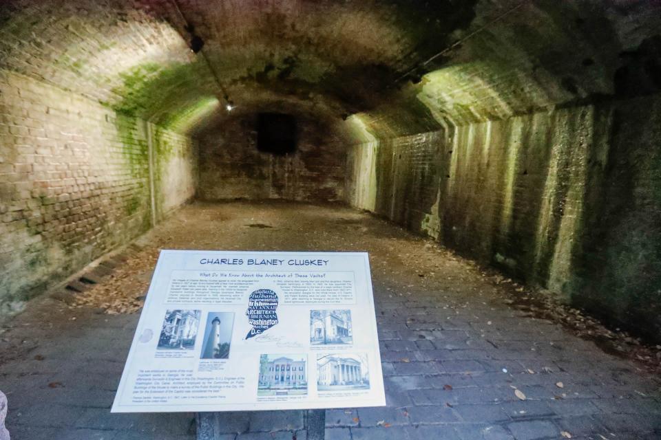 A marker provides information on Charles Cluskey, the architect who designed the vaults located at lower Factors Walk near Savannah City Hall.